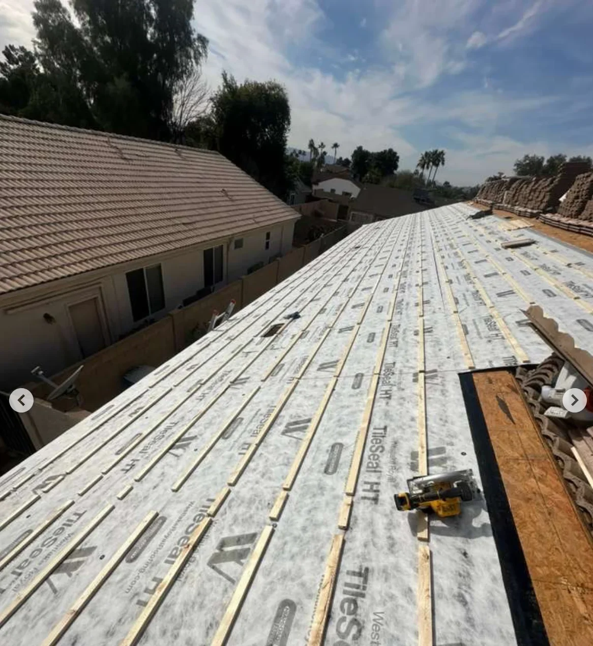 Roof deck with white underlayment, ice and water shield, and wooden framing during installation