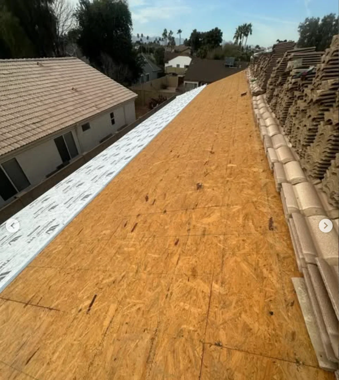 OSB roof decking with white underlayment membrane installed on residential roof structure